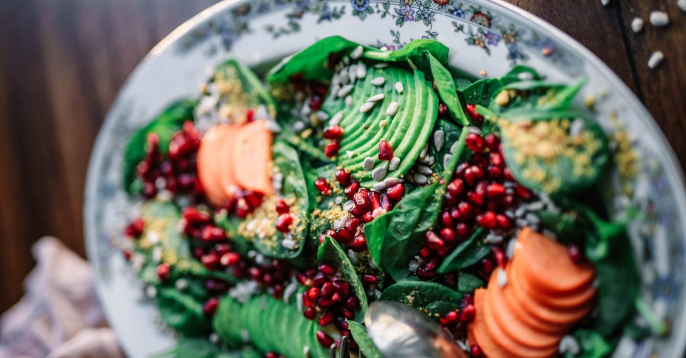 A vegan salad of Avocado, Pomegranate and Spinach Salad.