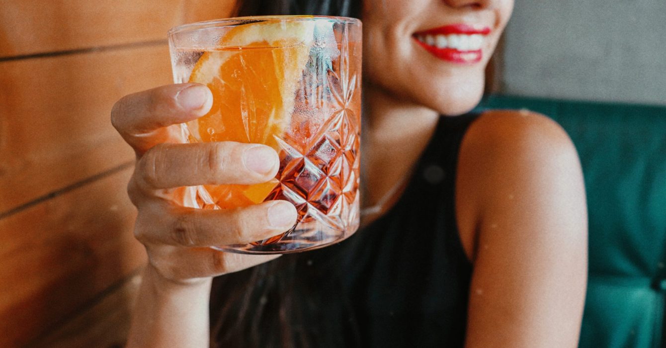 Woman holding drinking glass