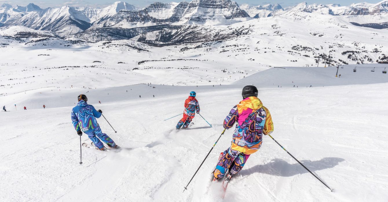 Three people skiing