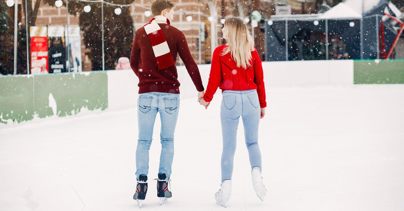 cute-couple-red-sweaters-having-fun-ice-arena