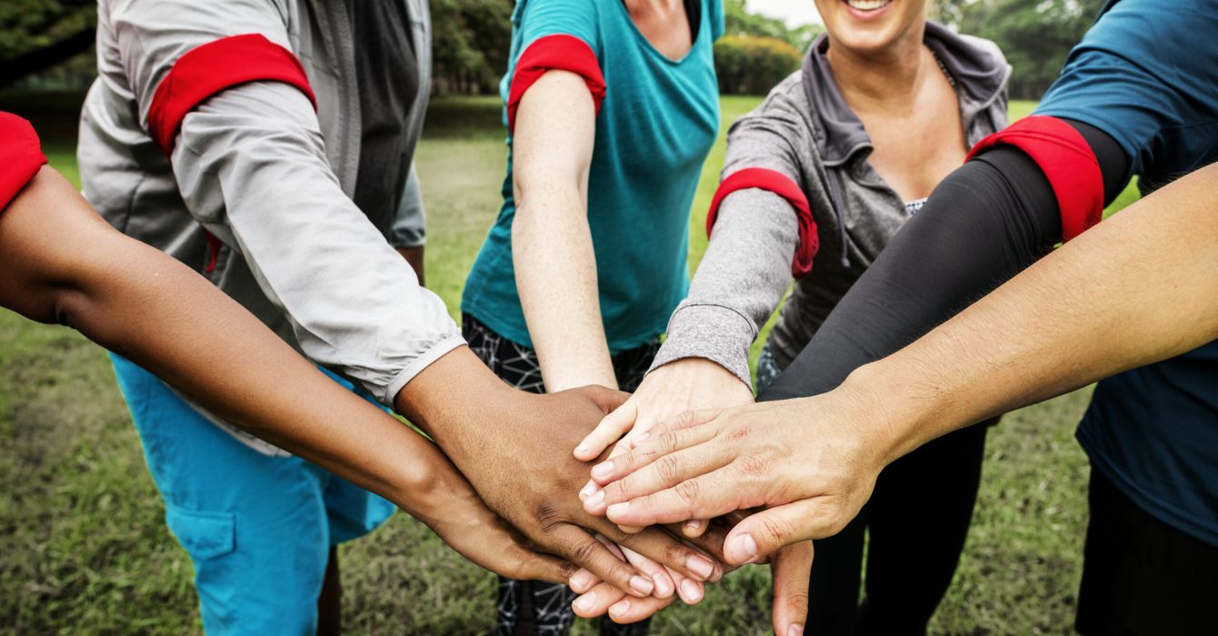 Diverse team stacking their hands