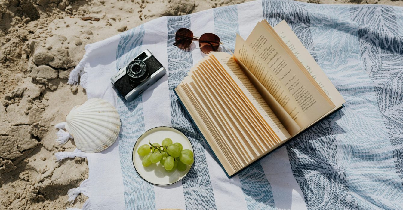 reading a book on the beach in summer