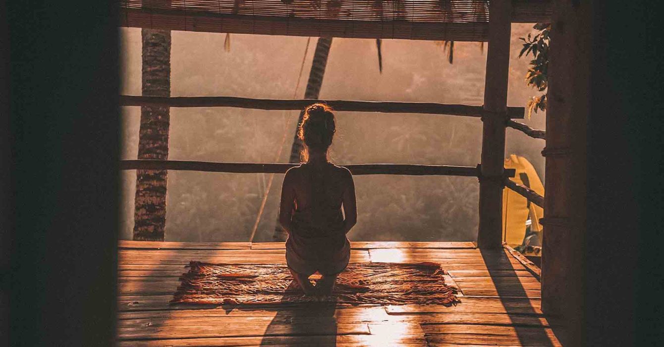 Woman meditating on a patio