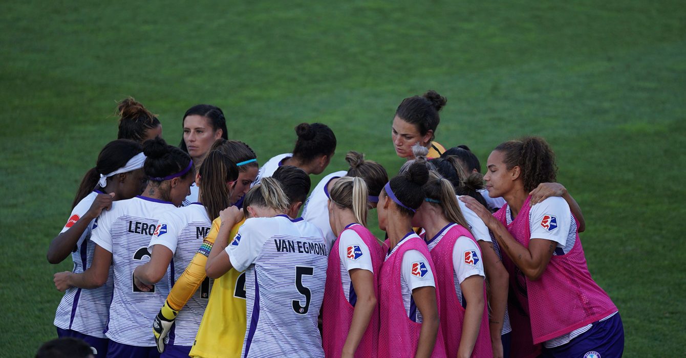 womens football team huddle