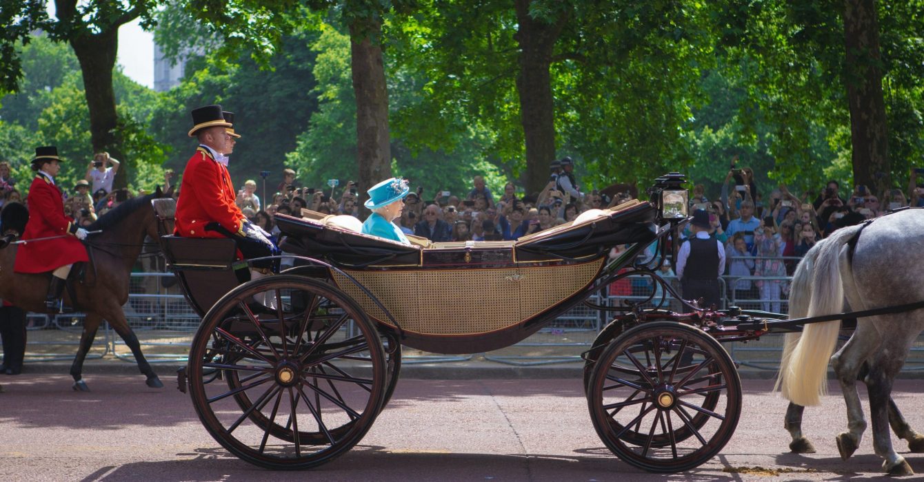 The Queen riding her horse-drawn carriage.