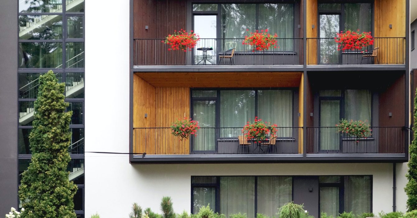 Building with balconies that have flowers