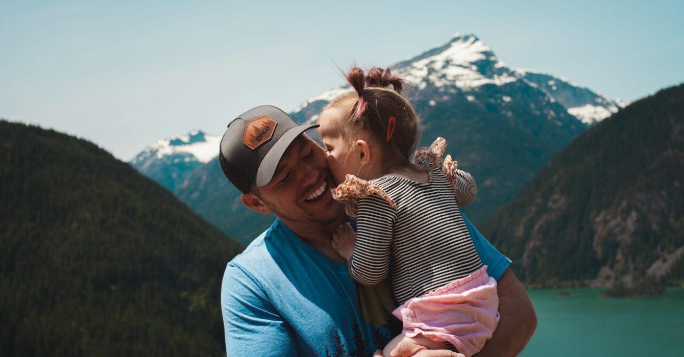 Little girl giving her dad a kiss