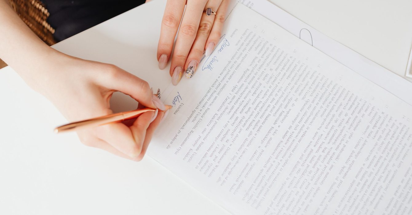 Woman's hands signing papers