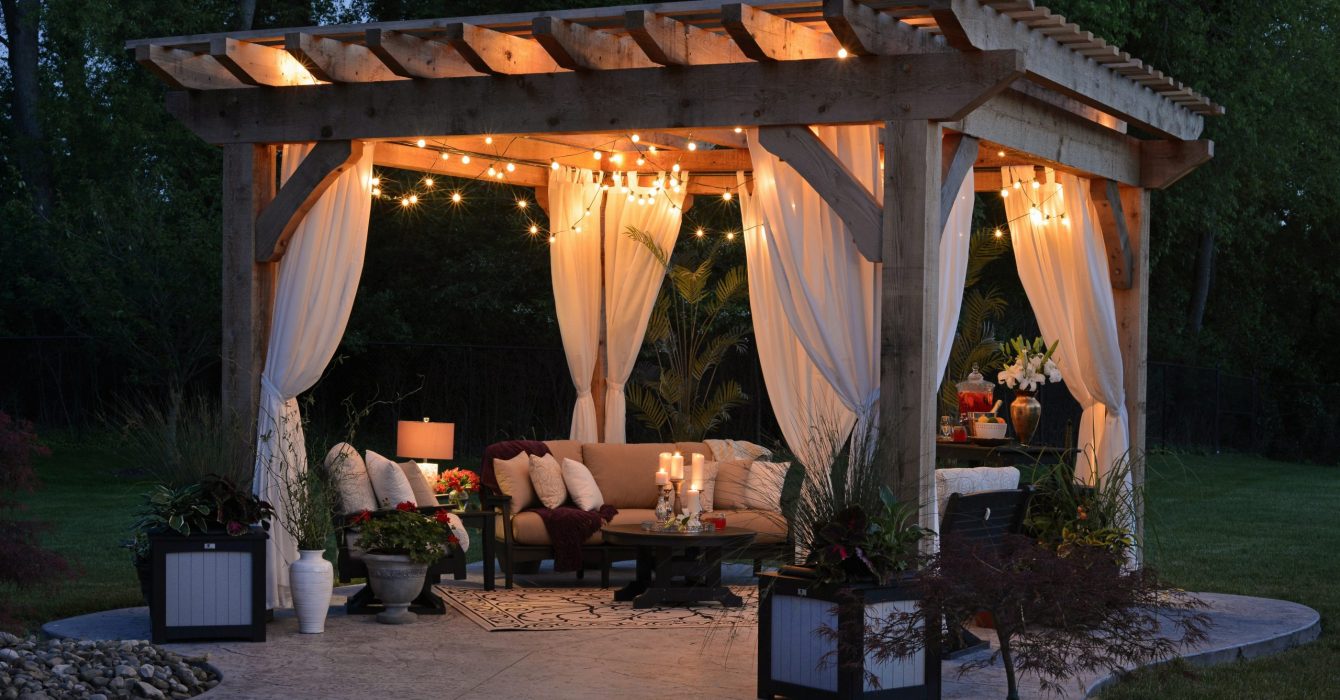 A cozy garden gazebo lit up with fairy lights.
