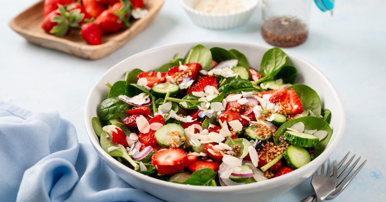 Summer Strawberry and spinach salad on a blue background