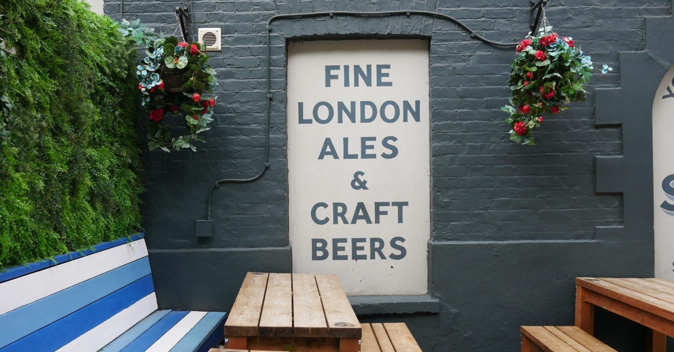 Wooden picnic tables at a pub's backyard