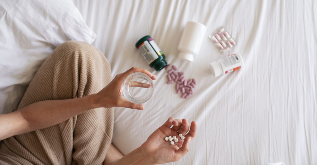 top-view-woman-taking-medication